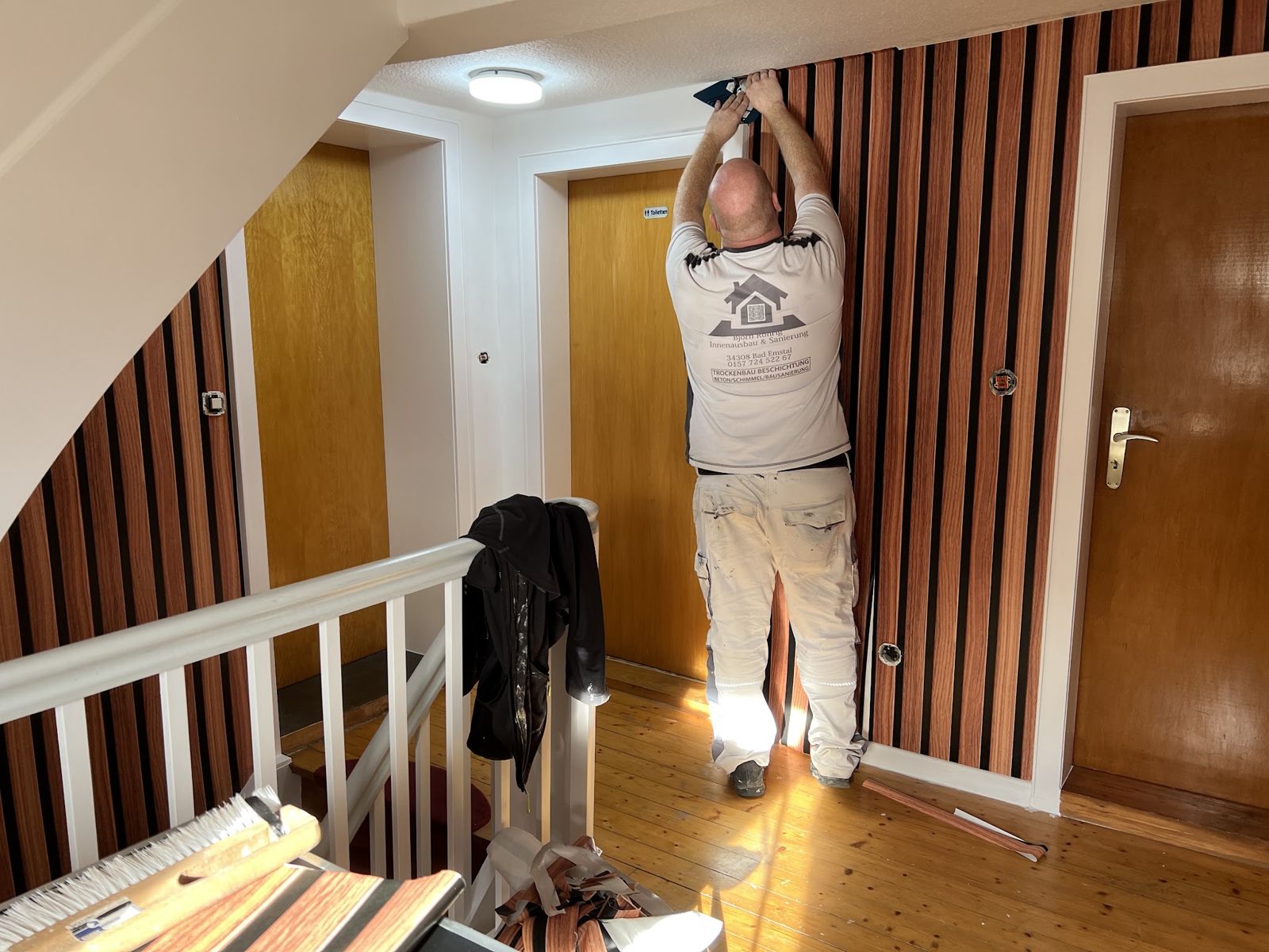 Montage von Holzlamellen im Treppenhaus